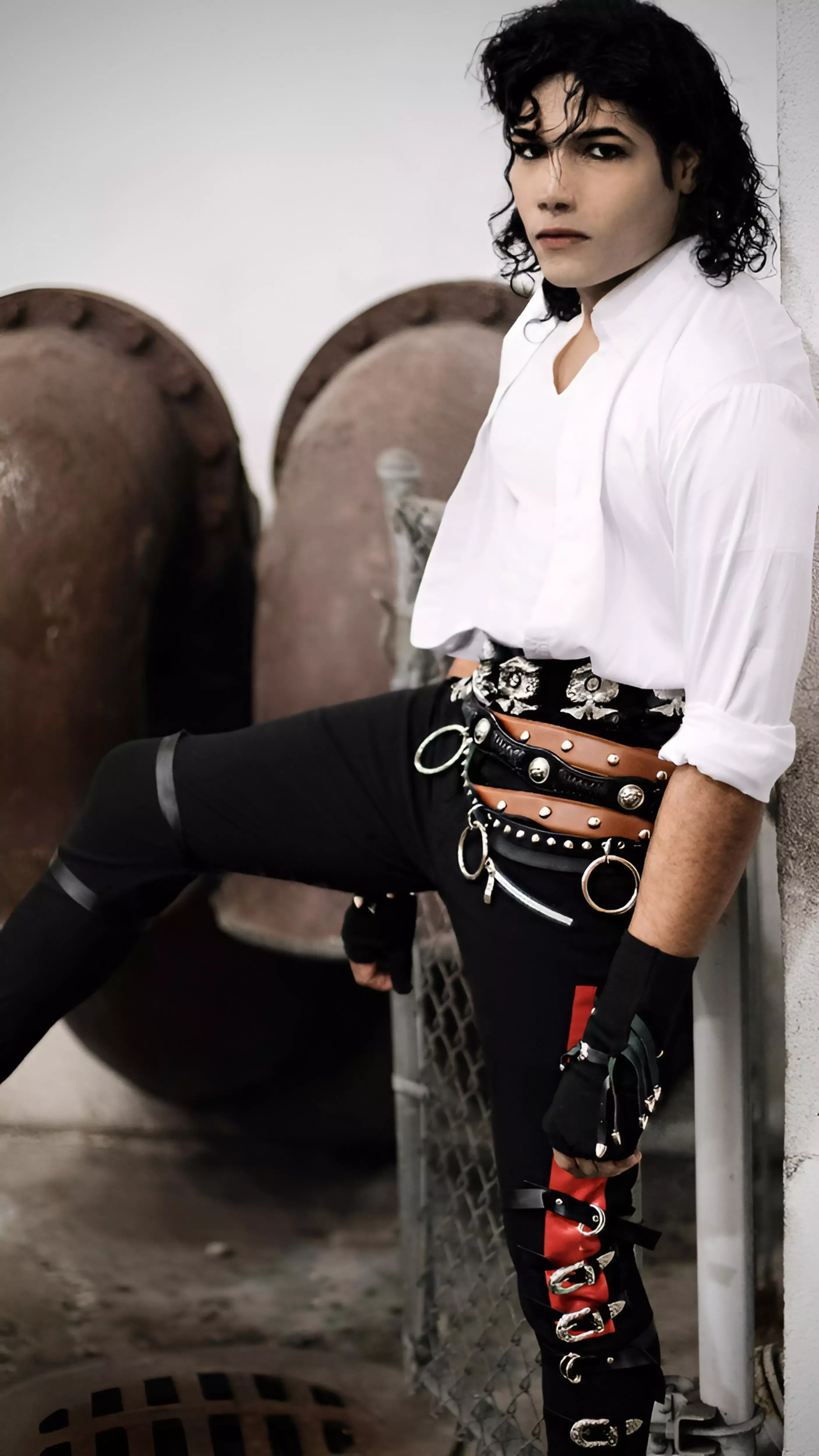 Michael Jackson impersonator MJ3 posing in a Dirty Diana costume with fingerless buckle wrapped gloves in Dubai portrait